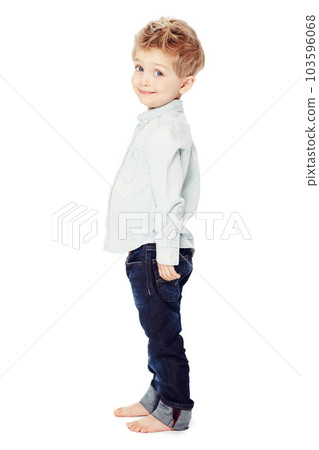Cute, smile and portrait of a child with fashion isolated on a white background in a studio. Adorable, happy and a little boy as a clothes model in jeans for youth with happiness and smiling 103596068