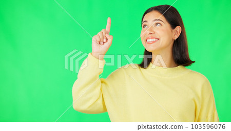 Portrait, point and branding with a woman on a green screen background in studio for marketing or product placement. Hand gesture, advertising and options with an attractive young female on chromakey 103596076