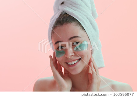 Portrait, skincare and woman with eye mask happy in studio for beauty, collagen and anti aging on pink background. Face, patches and female model with skin cosmetics, facial and hydration treatment Portrait, skincare and woman with eye mask happy in studio for beauty, collagen and anti aging on pink background. Face, patches and female model with skin cosmetics, facial and hydration treatment 103596077