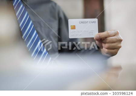 The businessman hand holding credit card enjoying doing online shopping and using laptop enter their card number in-app to purchase and payment in internet store The businessman hand holding credit card enjoying doing online shopping and using laptop enter their card number in-app to purchase and payment in internet store 103596124