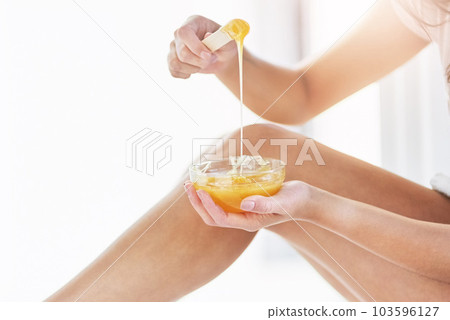 Theyll be smooth to the touch soon. Closeup shot of an unrecognizable woman waxing her legs in the bathroom at home. Theyll be smooth to the touch soon. Closeup shot of an unrecognizable woman waxing her legs in the bathroom at home. 103596127