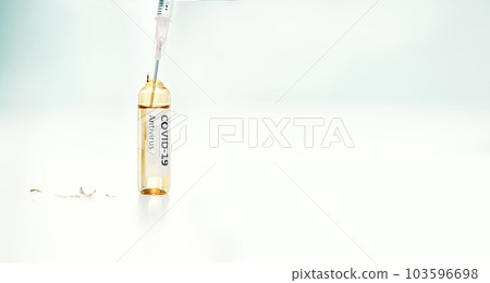 So small but itll save so many lives. a syringe extracting medication from an ampoule with 2019-nCov on it. 103596698