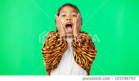 Girl child, shock face and green screen studio with tiger pyjamas, costume and wow with hands on face. Female kid, surprise facial expression and mock up portrait for news with space by background 103596705