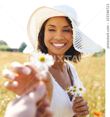 Earth laughs in flowers. a beautiful woman receiving a flower. 103596723