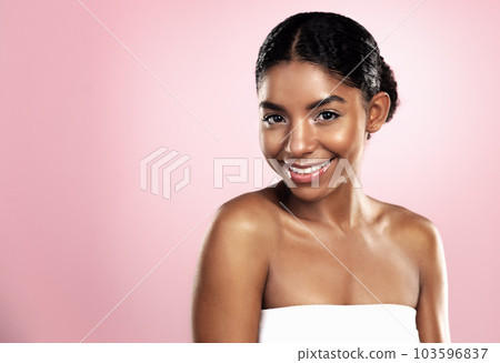 Portrait, happy woman and face for skincare on pink background, studio and mockup for clean dermatology. African, female model and natural beauty with confidence, glowing skin and aesthetic cosmetics Portrait, happy woman and face for skincare on pink background, studio and mockup for clean dermatology. African, female model and natural beauty with confidence, glowing skin and aesthetic cosmetics 103596837