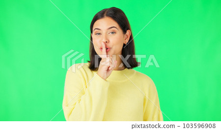 Green screen, happy face and secret woman with finger on lips, wink and privacy in studio. Portrait of female model, silence and shush for quiet, gossip and whisper emoji for confidential surprise 103596908