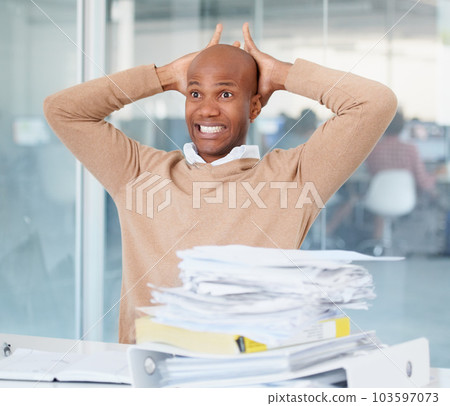 Stress, documents and mistake with a business man in his office, sitting at a desk while working on a problem. Audit, tax and compliance with a black male employee suffering from burnout at work 103597073