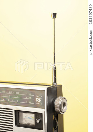 Old transistor radio on a yellow background 103597489