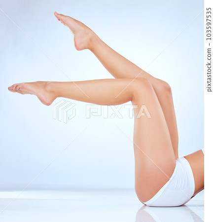 She just shines. Shot of an unrecognisable woman showing her legs while posing in the studio. 103597535