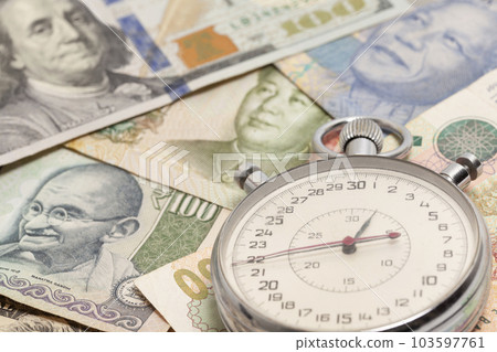 Stopwatch with International currencies.. Time is money concept Stopwatch with International currencies.. Time is money concept 103597761