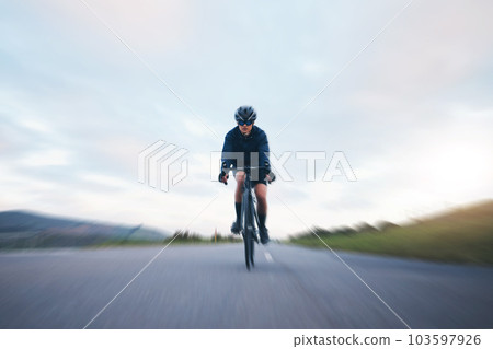 Fast, race and cycling with woman in road for training, competition and championship. Workout, sports and triathlon with female cyclist riding on bike for freedom, exercise and speed with motion blur 103597926