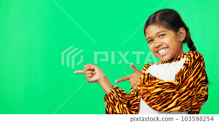 Showing, product placement and face of a child on a green screen isolated on a studio background. Laughing, happy and a portrait of a young girl pointing to mockup space for branding and advertising 103598254