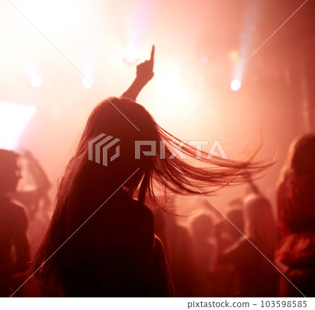 Dancing, club and back of woman at a concert, disco event or psychedelic trance festival. Night, energy and female person doing dance or moving to a song with red light at techno party or show. Dancing, club and back of woman at a concert, disco event or psychedelic trance festival. Night, energy and female person doing dance or moving to a song with red light at techno party or show. 103598585