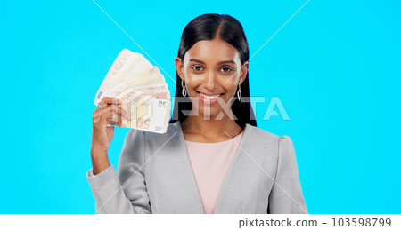 Rich, portrait or excited Indian woman with money success on blue background in studio with smile. Wealthy, finance or happy girl with cash profit, lottery jackpot or euros by winning a bonus prize 103598799