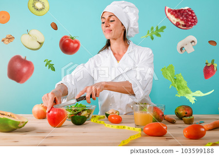 Woman chef prepares a new magical receipt with fruits 103599188