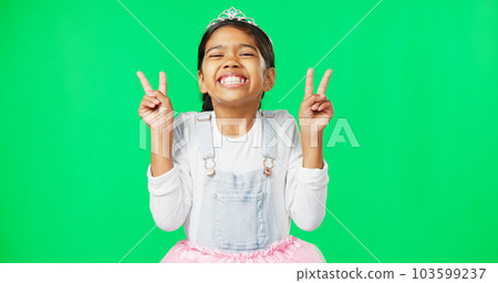 Peace, fun and hand gesture with a girl on a green screen background in studio feeling silly or carefree. Portrait, dance and emoji with an adorable little female child looking goofy or playful 103599237