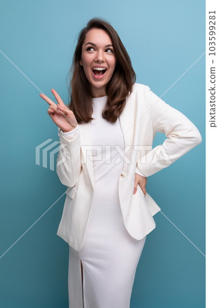 vertical portrait of a brunette woman in an elegant dress with a grimace and emotions on her face vertical portrait of a brunette woman in an elegant dress with a grimace and emotions on her face 103599281