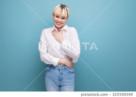 portrait of a young caucasian woman with a short haircut dressed in a white shirt among a blue 103599399