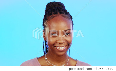 Face, laughter and smile of an African girl in studio isolated on a blue background for fun or humor. Portrait, happy and laughing with an attractive young female enjoying a joke, comic or funny come Face, laughter and smile of an African girl in studio isolated on a blue background for fun or humor. Portrait, happy and laughing with an attractive young female enjoying a joke, comic or funny come 103599549