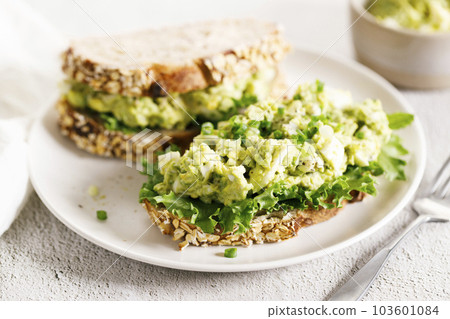 Healthy breakfast toast with avocado egg salad. 103601084