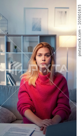 Hard education. Shocked woman. Home study. Frustrated casual female student sitting desk with documents in light room interior . 103601635
