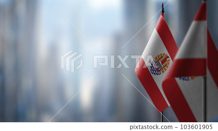 Small flags of the French Polynesia on an abstract blurry background 103601905