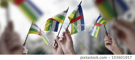 A group of people holding small flags of the Central African Republic in their hands A group of people holding small flags of the Central African Republic in their hands 103601957