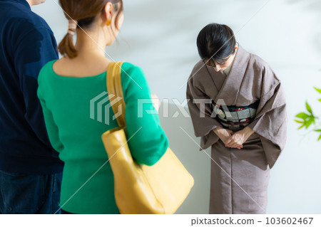A couple guided by a proprietress in a kimono A couple guided by a proprietress in a kimono 103602467