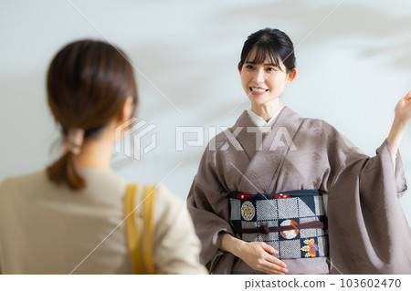 A couple guided by a proprietress in a kimono A couple guided by a proprietress in a kimono 103602470