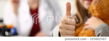 Little girl holding thumbs up in doctor office Little girl holding thumbs up in doctor office 103602487