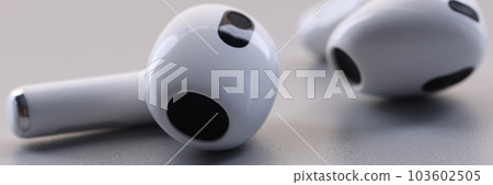 Bluetooth wireless headphones or earbuds or earphones on gray background Bluetooth wireless headphones or earbuds or earphones on gray background 103602505