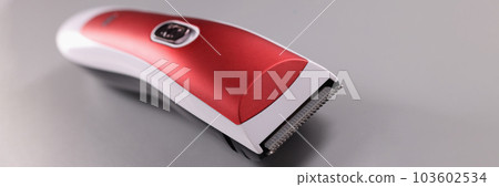 Red hair clipper on a gray background 103602534