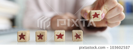 Person holds die with fifth star in hand Person holds die with fifth star in hand 103602587