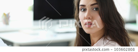 Woman holds musical notes and plays home synthesizer 103602808