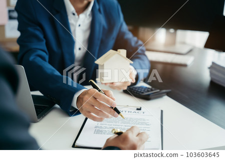 Considering buying a home, investing in real estate. Broker signs a sales agreement. agent, lease agreement, successful deal. 103603645
