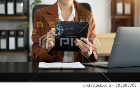 Business woman working on tablet and laptop computer with digital document, managing files data, paperless workflow, data search, cloud technology. 103603702