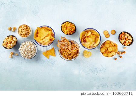 Salty snacks, party mix. An assortment of crispy appetizers, shot from above 103603711
