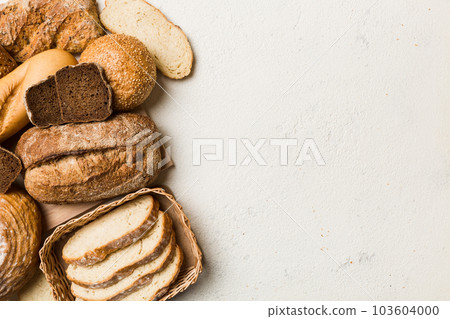 Homemade natural breads. Different kinds of fresh bread as background, top view with copy space Homemade natural breads. Different kinds of fresh bread as background, top view with copy space 103604000