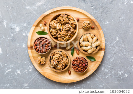 Walnut kernel halves, in a wooden bowl. Close-up, from above on colored background. Healthy eating Walnut concept. Super foods with copy space 103604032