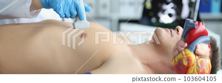Man on ultrasound of heart in cardiology center 103604105