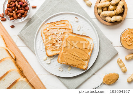 Peanut butter sandwiches or toasts on light table background.Breakfast. Vegetarian food. American cuisine top view vith copy space 103604167