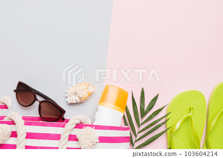 Beach accessories straw hat and seashell on colored table. Summer concept background 103604214