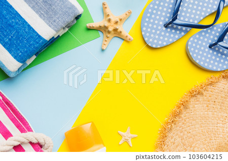 Beach accessories straw hat and seashell on colored table. Summer concept background 103604215