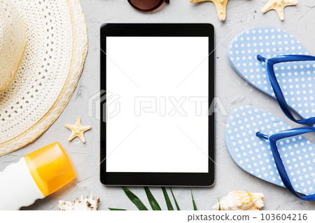 Flat lay composition with tablet and beach accessories on colored background. Tablet computer with blank screen mock up with copy space Flat lay composition with tablet and beach accessories on colored background. Tablet computer with blank screen mock up with copy space 103604216
