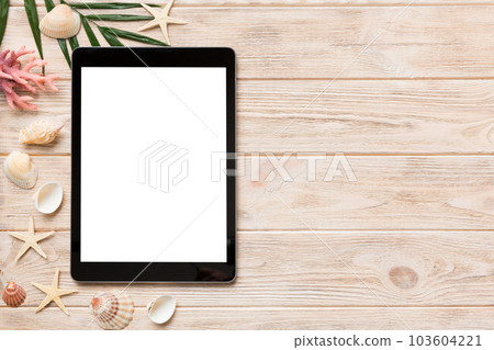 Flat lay composition with tablet and beach accessories on colored background. Tablet computer with blank screen mock up with copy space Flat lay composition with tablet and beach accessories on colored background. Tablet computer with blank screen mock up with copy space 103604221