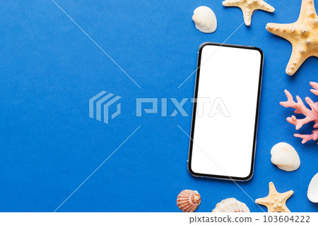 Flat lay composition with Phone and beach accessories on colored background. Smartphone with blank screen mock up with copy space Flat lay composition with Phone and beach accessories on colored background. Smartphone with blank screen mock up with copy space 103604222