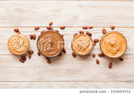 Glass jar with peanut butter on table background, top view space for text and close up Glass jar with peanut butter on table background, top view space for text and close up 103604532