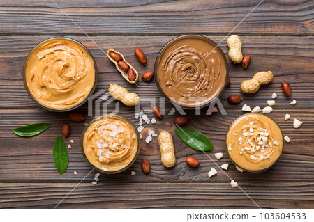 Glass jar with peanut butter on table background, top view space for text and close up Glass jar with peanut butter on table background, top view space for text and close up 103604533