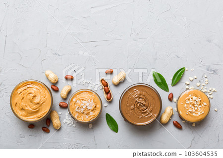 Glass jar with peanut butter on table background, top view space for text and close up Glass jar with peanut butter on table background, top view space for text and close up 103604535