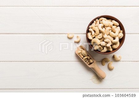 cashew nuts in wooden bowl on table background. top view. Space for text Healthy food cashew nuts in wooden bowl on table background. top view. Space for text Healthy food 103604589